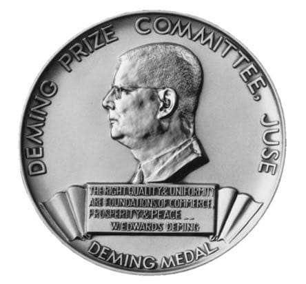 Silver Deming Medal awarded by JUSE (the Japanese Union of Scientists and Engineers), showing a profile portrait of Dr Deming encircled by the legend 'Deming Prize Committee — JUSE' and inscribed 'Deming Medal' below.