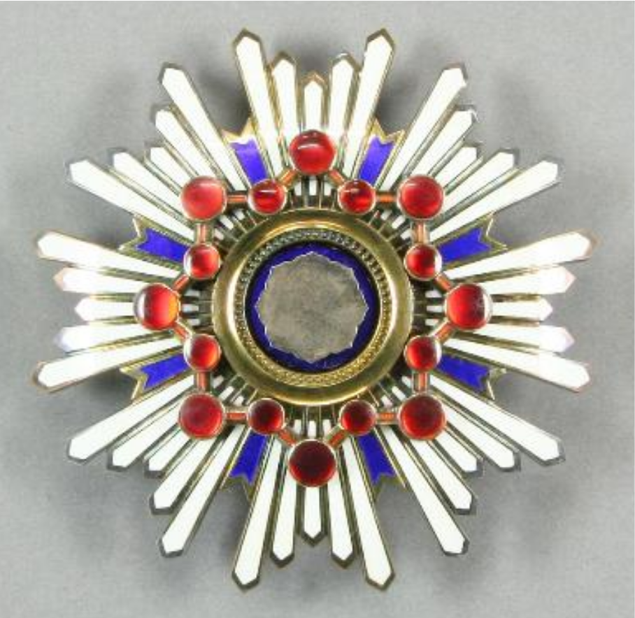 Japan’s Second Order Medal of the Sacred Treasure, a silver starburst medal with red and blue enamel details, awarded to Deming in 1960